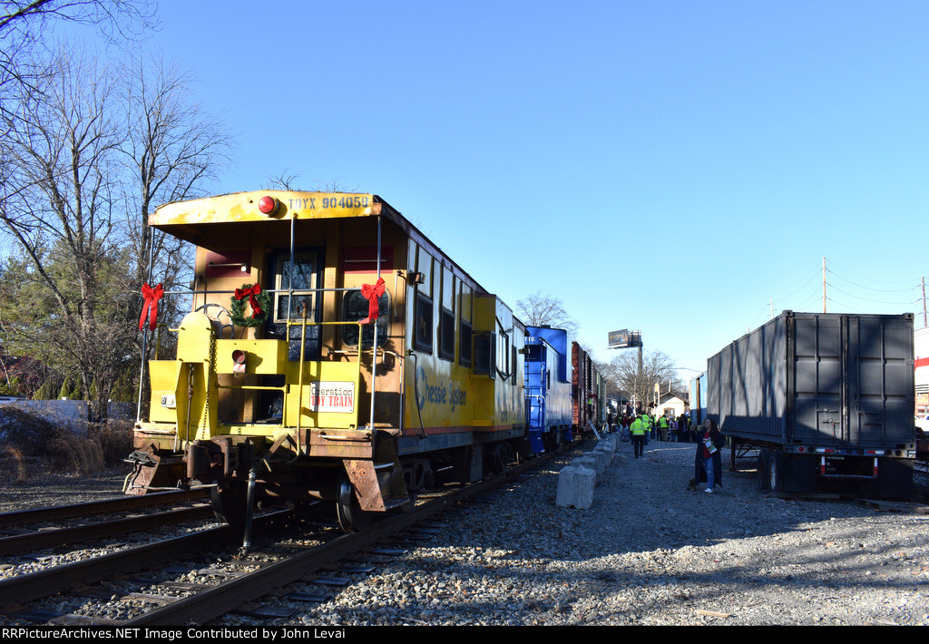 Chessie System Caboose # 904059 and Conrail Caboose # 22130 both on the rear of the TFT train in Rochelle Park while gifts are being distributed to the crew